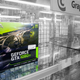 A lonely EVGA GPU sits on an otherwise empty store shelf.